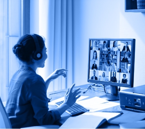 Woman sitting at desk on a teleconference meeting