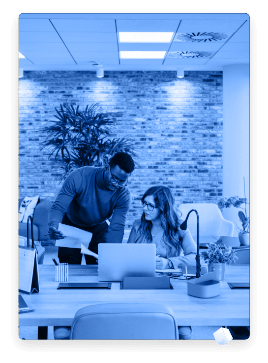 Man an woman reviewing papers at a desk