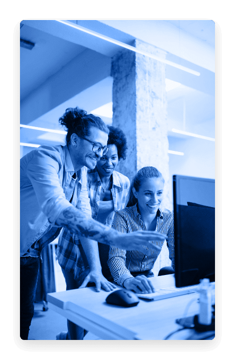 Group of people viewing computer screen at a desk