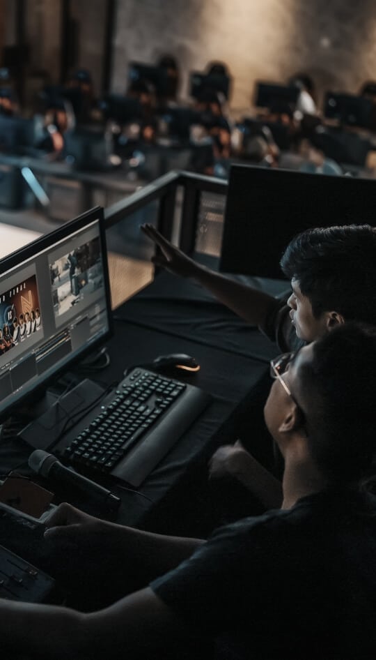 Two employees looking at a desktop screen