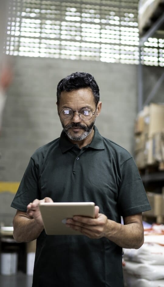 Man in warehouse using a tablet