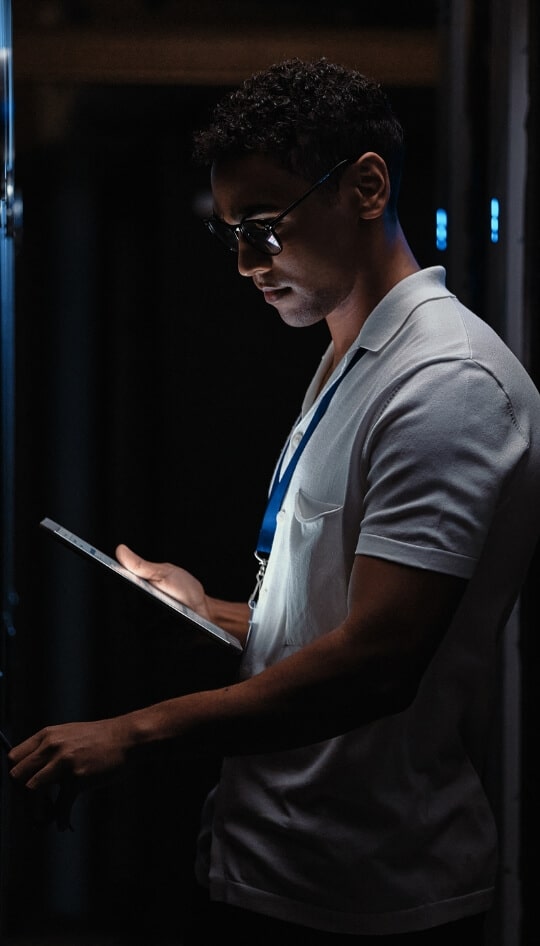 Man with ID badge using a tablet