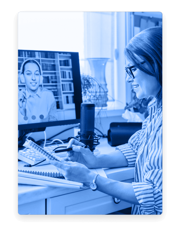 Two women on a video call looking at notes