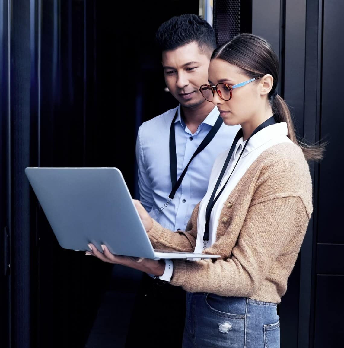 Two coworkers looking at a laptop together