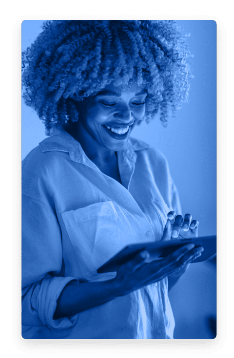 Woman smiling looking down at a tablet