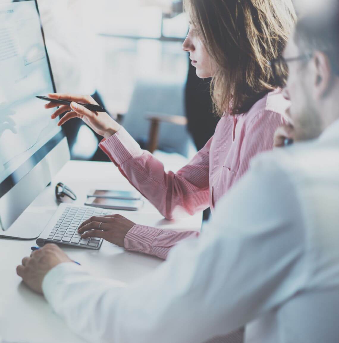 Man and woman working on a desktop together