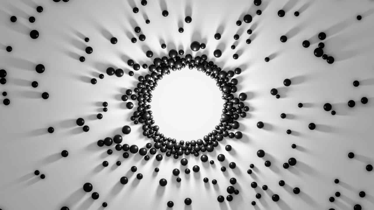 Black spheres collecting towards a center point to form a circle