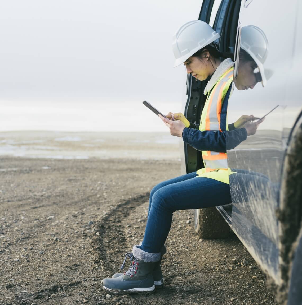 Female construction working using an iPad