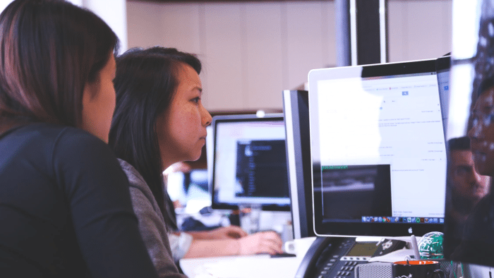 Two women working together on a computer