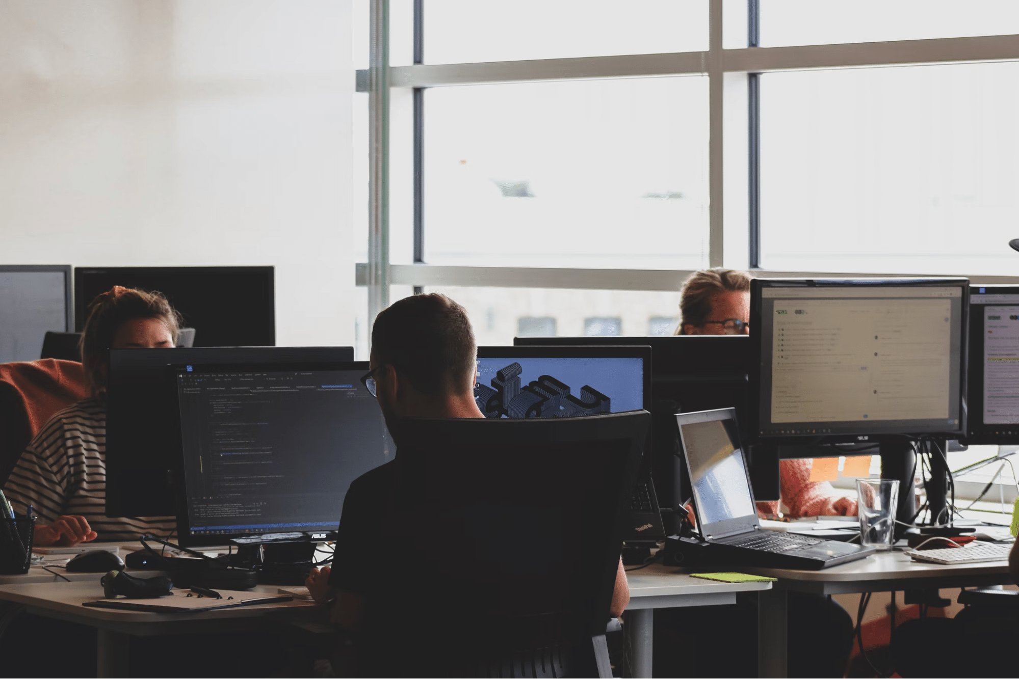 Coworkers working on desktops in the office